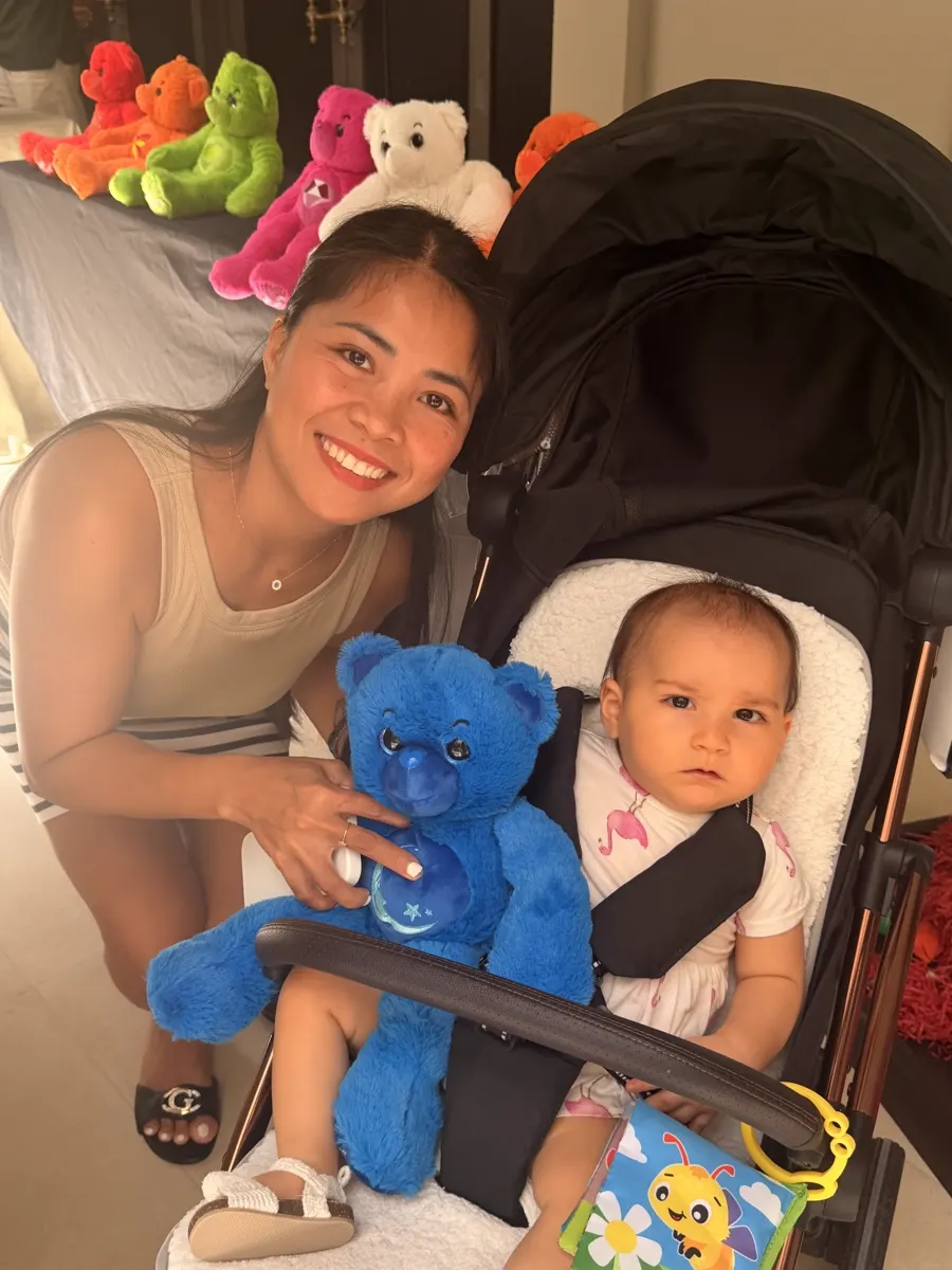 A toddler at a YogaBears birthday party with the blue bear character